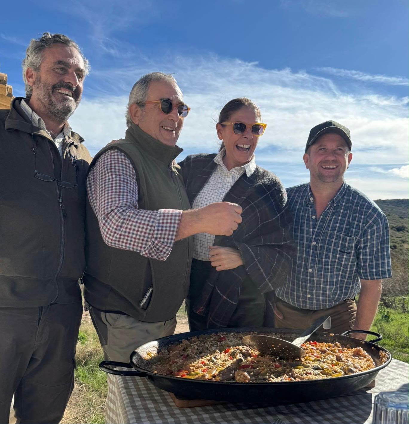 Group sharing paella outdoors, Spain